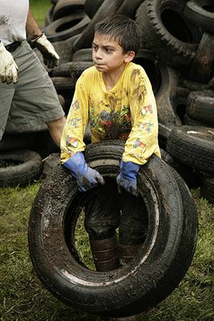 Child picking up tire